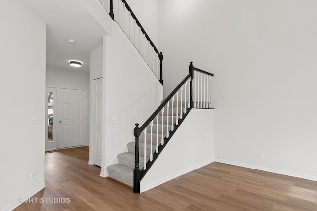 stairs with baseboards and wood finished floors