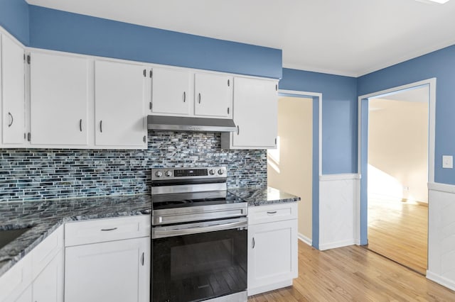 kitchen featuring under cabinet range hood, white cabinetry, and electric range