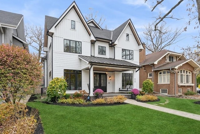 modern inspired farmhouse featuring a standing seam roof, metal roof, board and batten siding, and a front yard