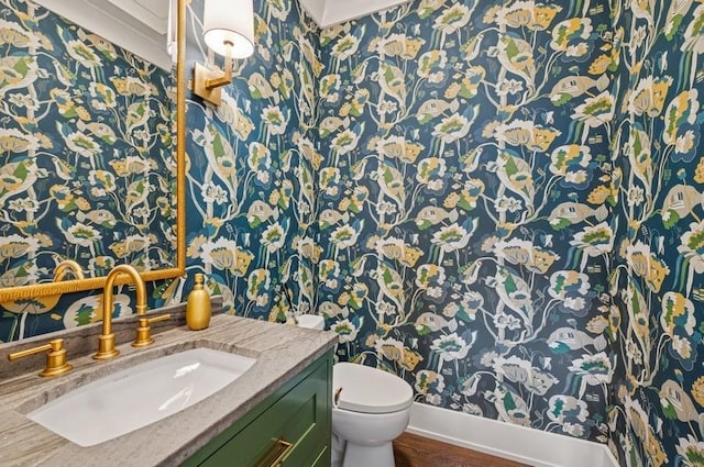 bathroom featuring wood finished floors, vanity, and toilet