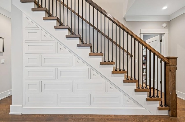 staircase featuring recessed lighting, baseboards, and wood finished floors