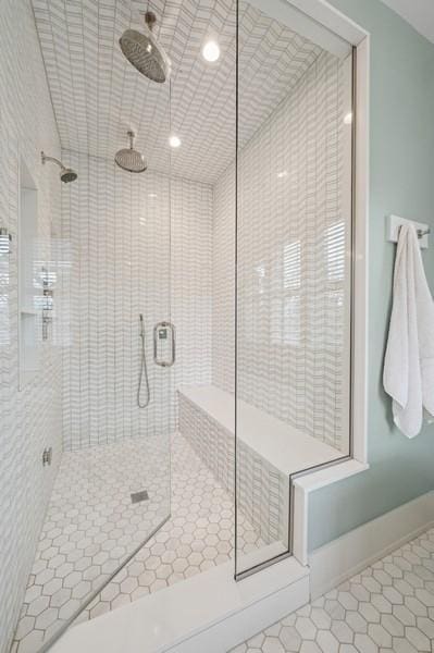 bathroom featuring a stall shower, baseboards, and tile patterned floors