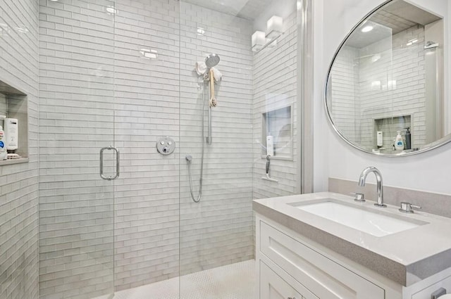 full bathroom with a stall shower and vanity