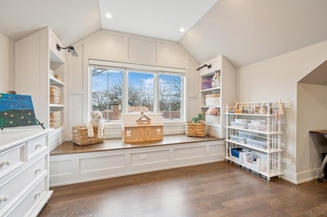 interior space with vaulted ceiling and dark wood-style floors