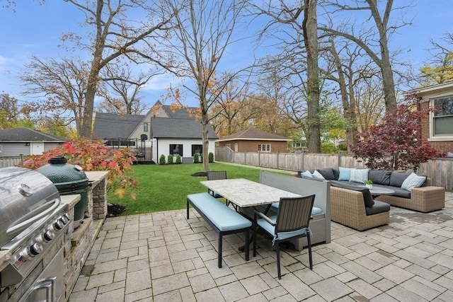 view of patio featuring an outdoor kitchen, an outdoor hangout area, outdoor dining space, a fenced backyard, and an outdoor structure