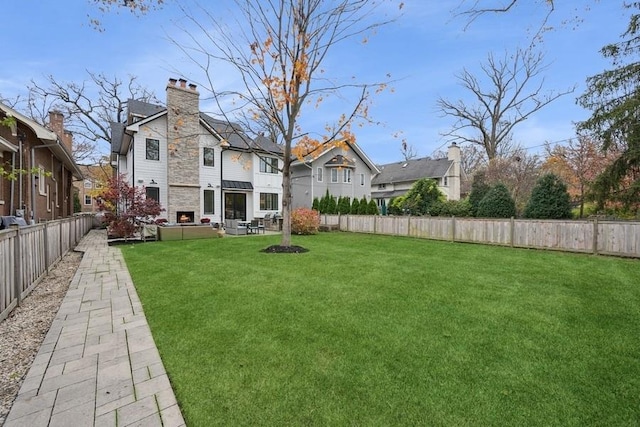 view of yard featuring a fenced backyard and a residential view