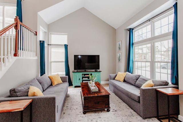 living room featuring light wood-type flooring and high vaulted ceiling