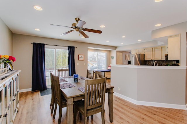 dining space featuring baseboards, ceiling fan, light wood finished floors, and recessed lighting