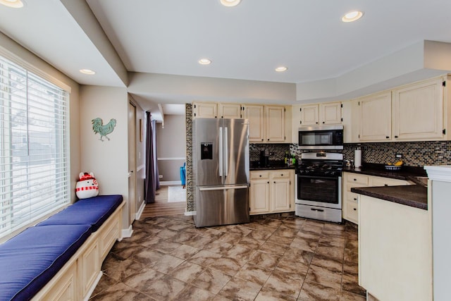 kitchen with stainless steel appliances, dark countertops, recessed lighting, and tasteful backsplash