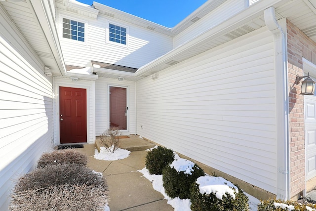 doorway to property with brick siding