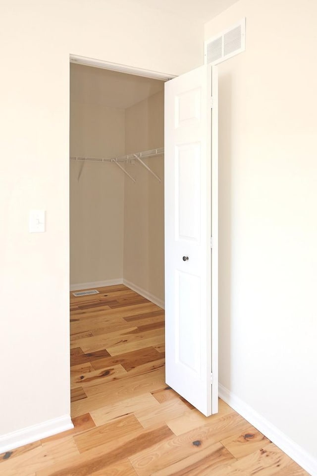 walk in closet featuring visible vents and light wood finished floors