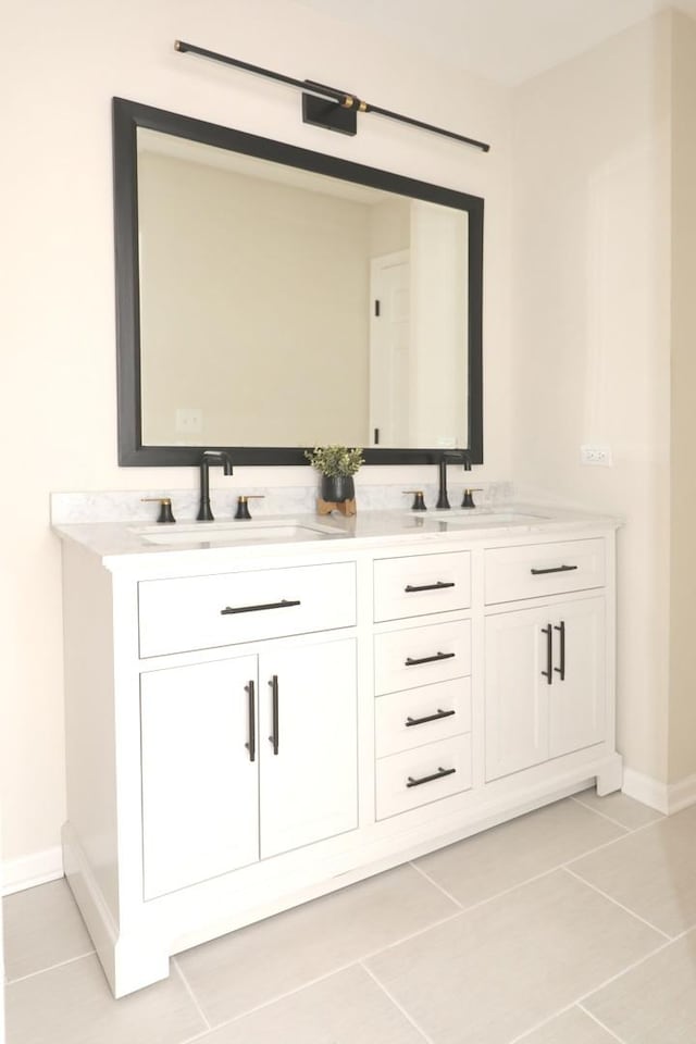 full bathroom featuring a sink, baseboards, and tile patterned flooring