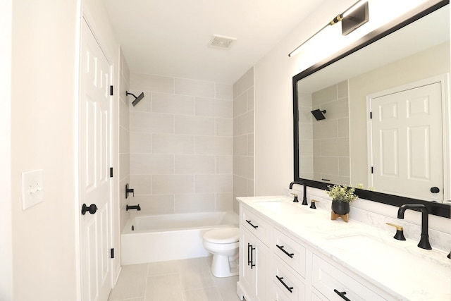 bathroom with tile patterned floors, tub / shower combination, a sink, and visible vents