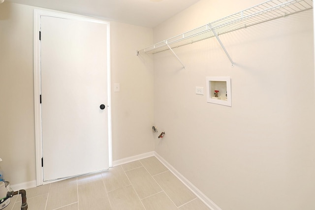 laundry area with baseboards, hookup for a washing machine, laundry area, and light tile patterned flooring