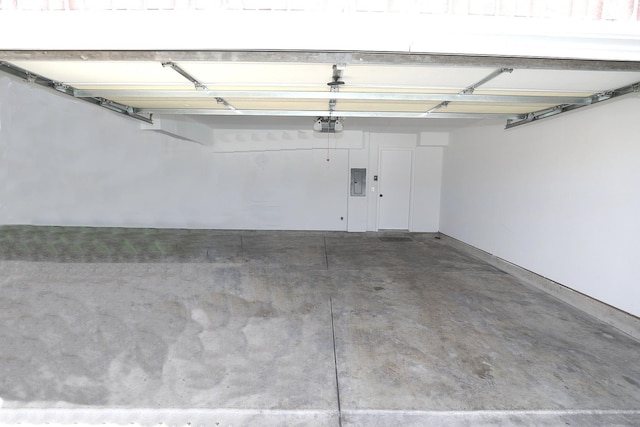 garage featuring a garage door opener and electric panel