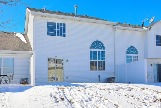 view of snow covered rear of property