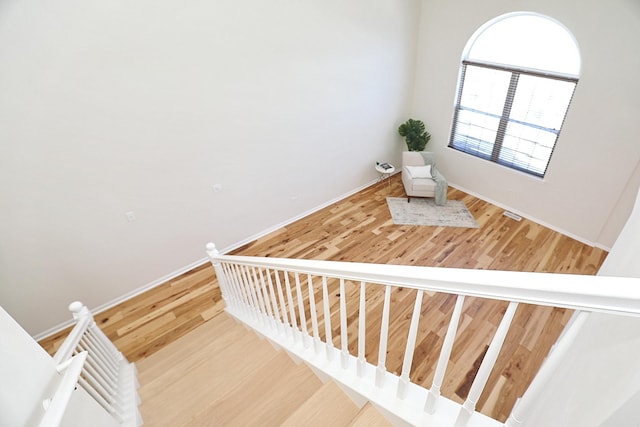 stairs with baseboards and wood finished floors