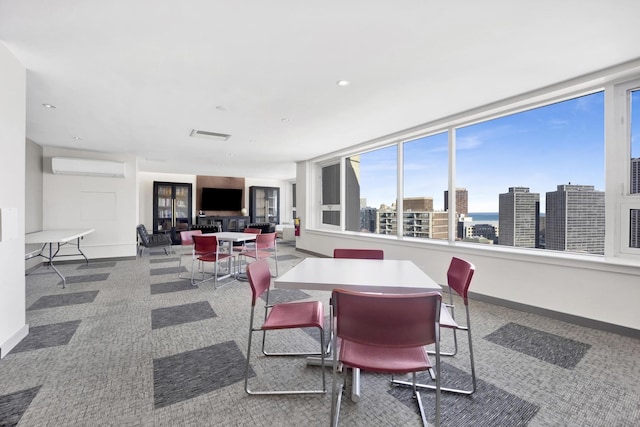 dining room with recessed lighting, carpet flooring, baseboards, and a wall mounted AC