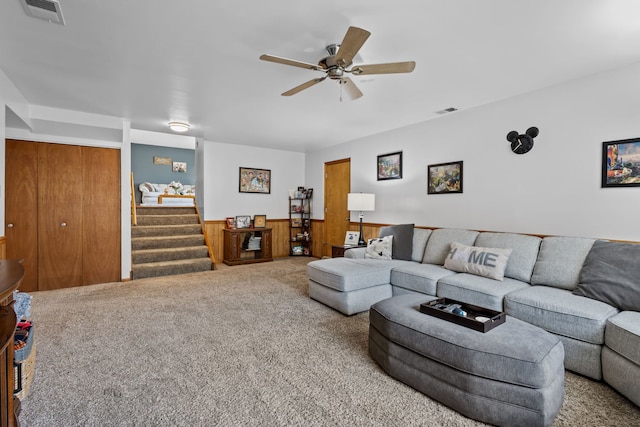 living area featuring stairs, wainscoting, carpet flooring, and visible vents