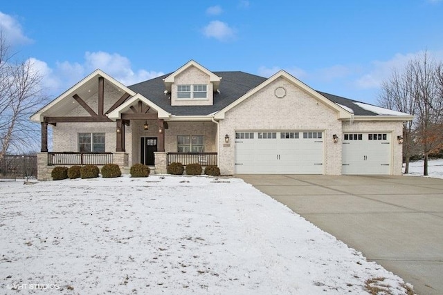 view of front of home featuring covered porch, concrete driveway, brick siding, and a garage