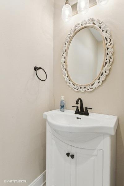 bathroom with vanity and baseboards