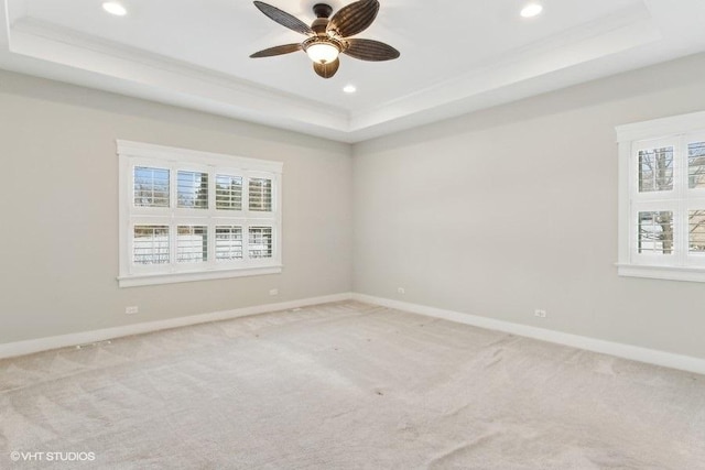 unfurnished room featuring light carpet, baseboards, a tray ceiling, and recessed lighting