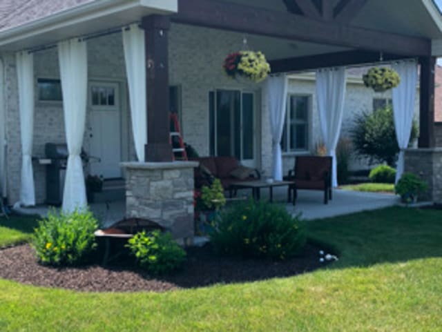 exterior space with a patio area and a lawn