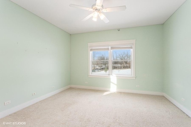 spare room featuring carpet, baseboards, and ceiling fan