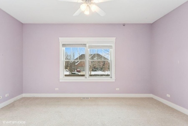 unfurnished room with carpet flooring, ceiling fan, visible vents, and baseboards