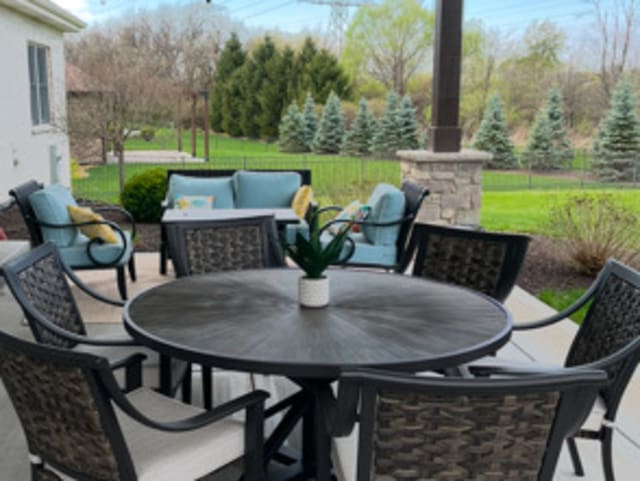 view of patio / terrace featuring outdoor dining area, fence, and an outdoor living space