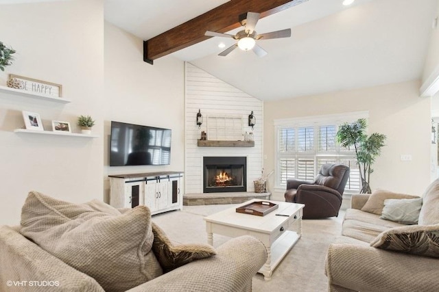 living room featuring a ceiling fan, light colored carpet, beamed ceiling, a fireplace, and high vaulted ceiling