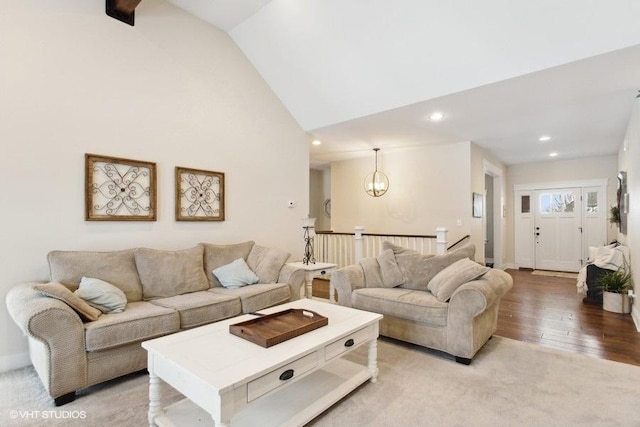 living room with high vaulted ceiling, light wood-style floors, an inviting chandelier, and recessed lighting