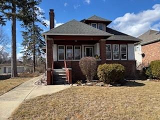 bungalow-style home featuring a front yard