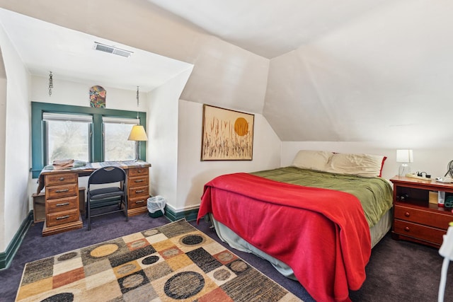 bedroom featuring baseboards, vaulted ceiling, visible vents, and dark carpet