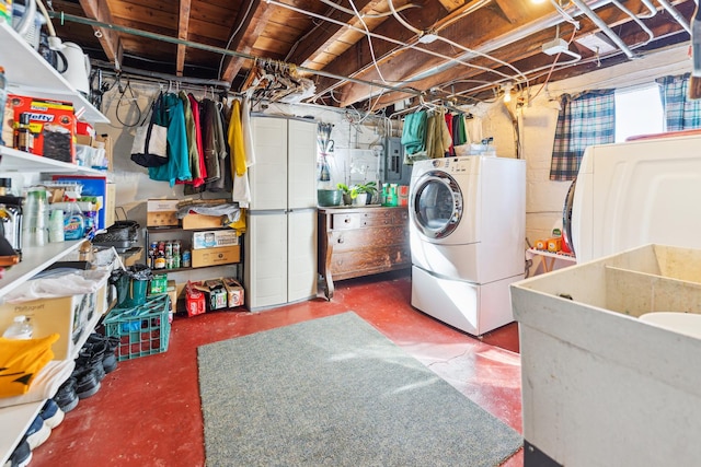 washroom with laundry area, electric panel, and washer and dryer