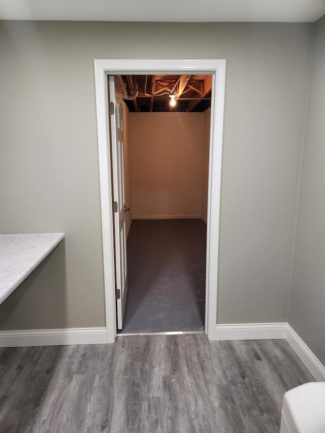 interior space featuring baseboards and wood finished floors