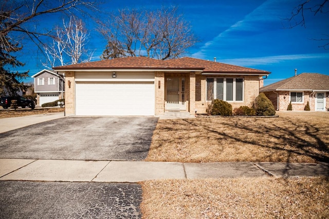 ranch-style home with brick siding, driveway, an attached garage, and roof with shingles