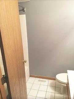 full bath with toilet, tile patterned flooring, baseboards, and vanity