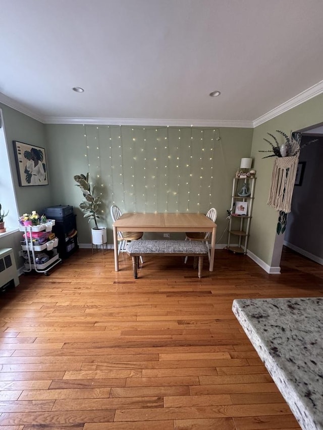 interior space with baseboards, light wood-style floors, and crown molding