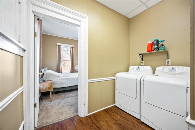 washroom featuring dark wood-style floors, washing machine and dryer, and laundry area