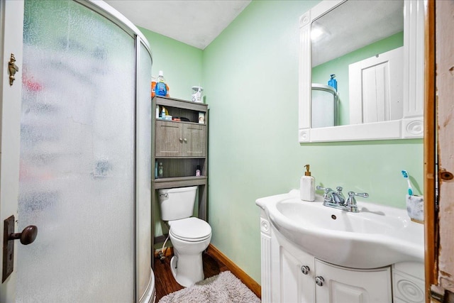 full bathroom with toilet, a shower stall, and vanity