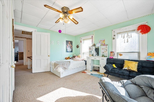 bedroom with a ceiling fan and carpet flooring