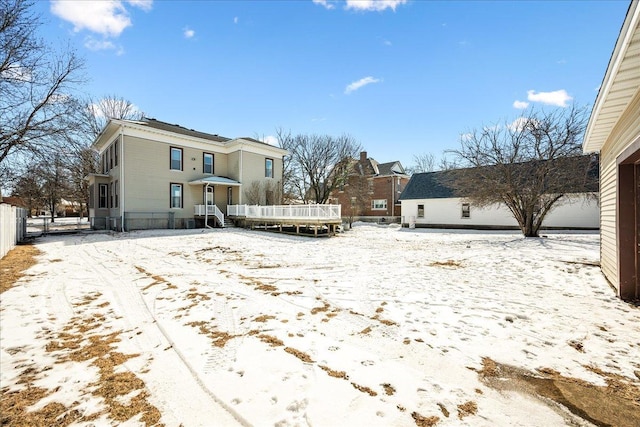 view of snow covered rear of property