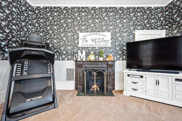 living room with light carpet, wallpapered walls, and a fireplace with flush hearth