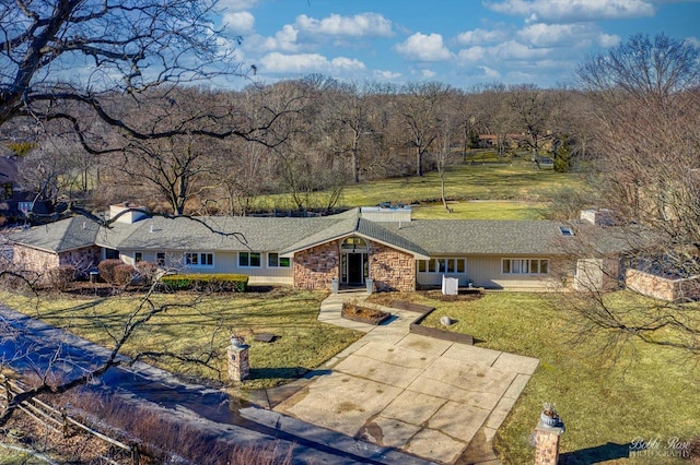 view of front of house with stone siding and a front yard