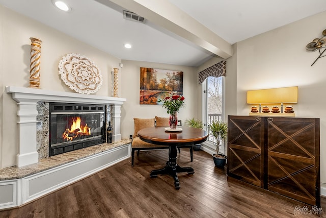 sitting room with beam ceiling, recessed lighting, visible vents, a high end fireplace, and wood finished floors