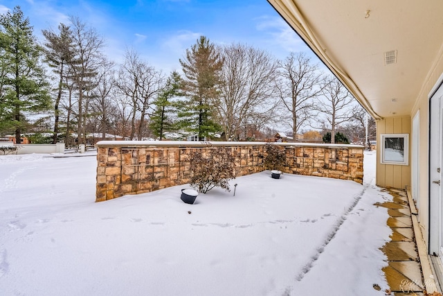 snowy yard with visible vents