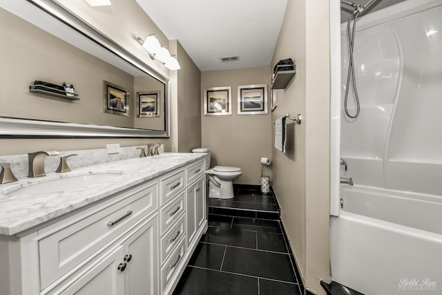 bathroom with double vanity, visible vents, toilet, a sink, and tile patterned flooring