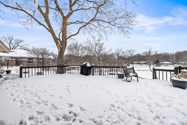 yard layered in snow featuring a wooden deck