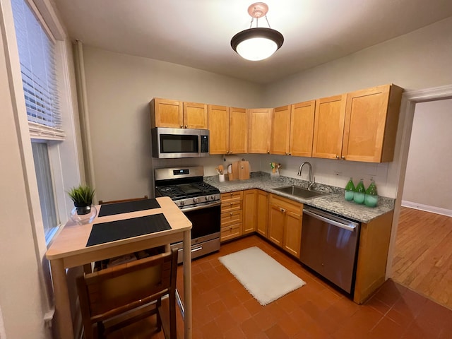 kitchen with stainless steel appliances, light countertops, and a sink